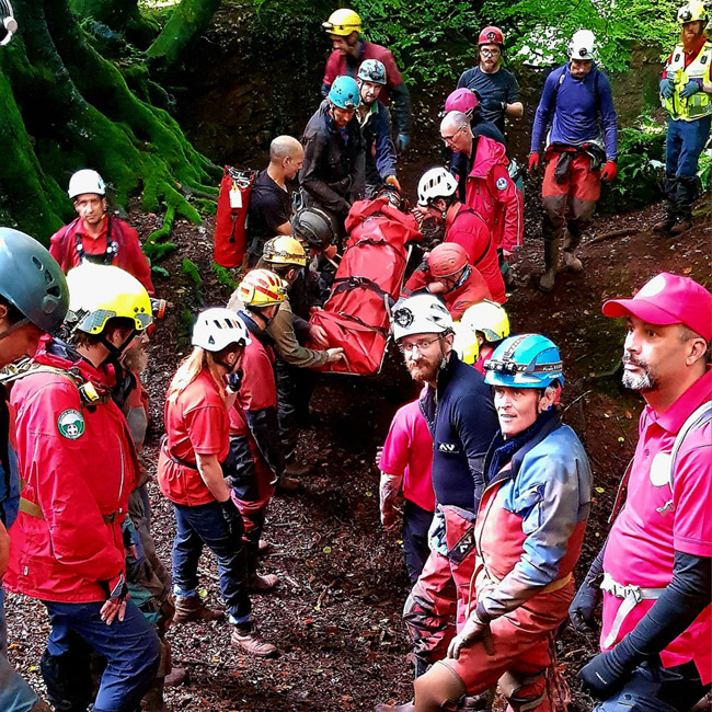 Rescuers from a range of teams, moving the stretcher